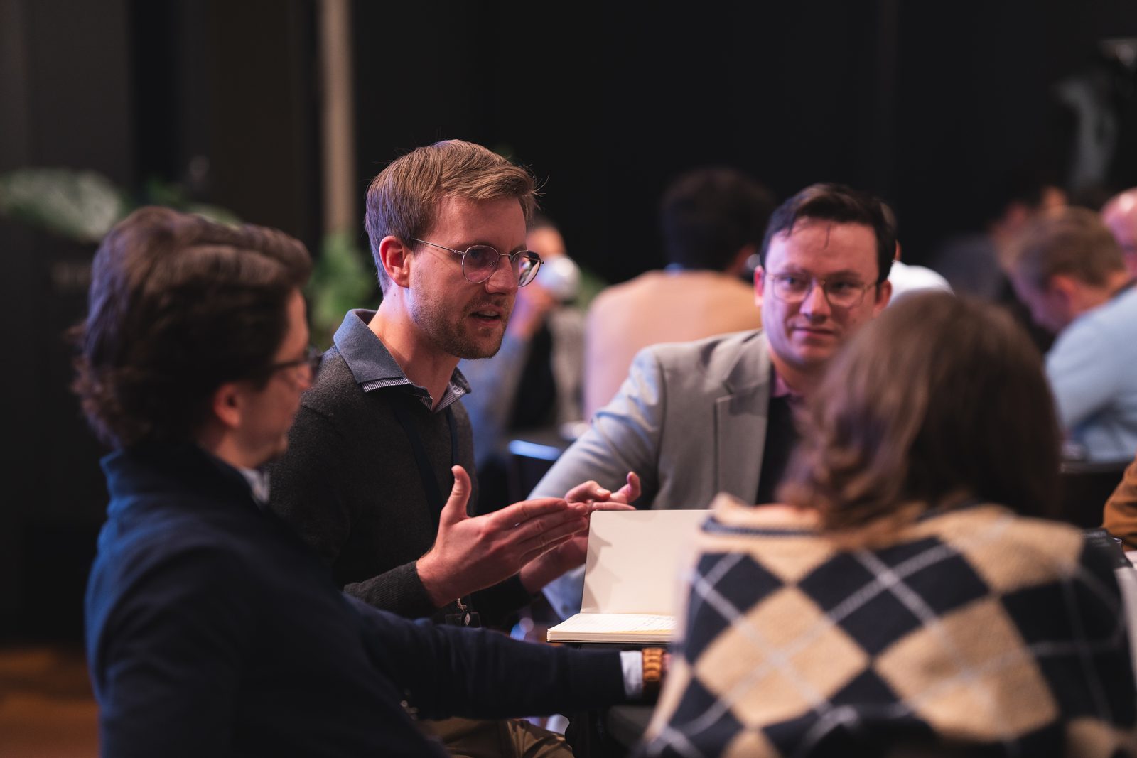 Members in conversation between sessions